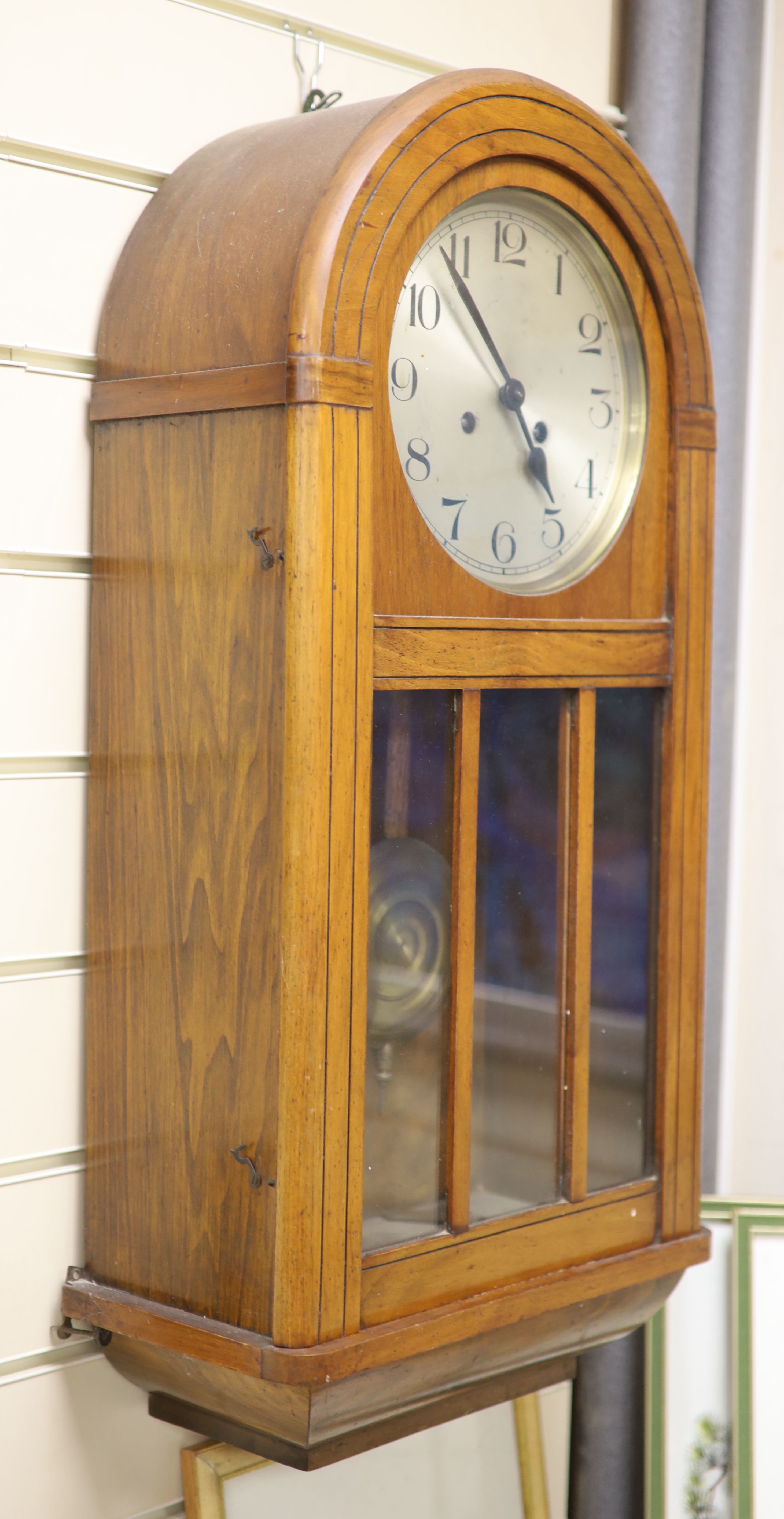 A 1920s walnut wall clock